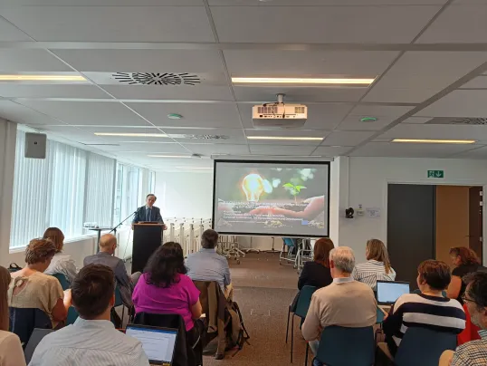 Man presenting at 9th SOIKE meeting