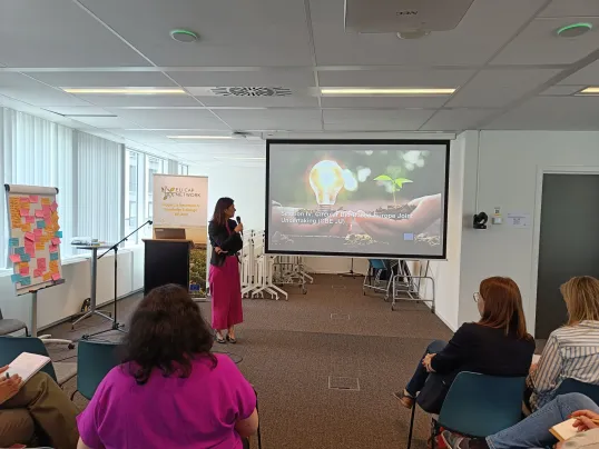Woman presenting at 9th SOIKE meeting